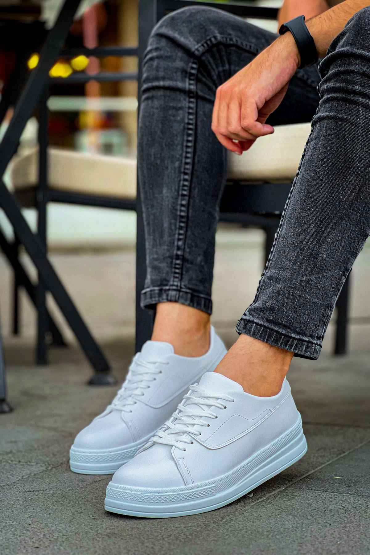 White lace-up sneakers with side logo detail and rubber cupsole