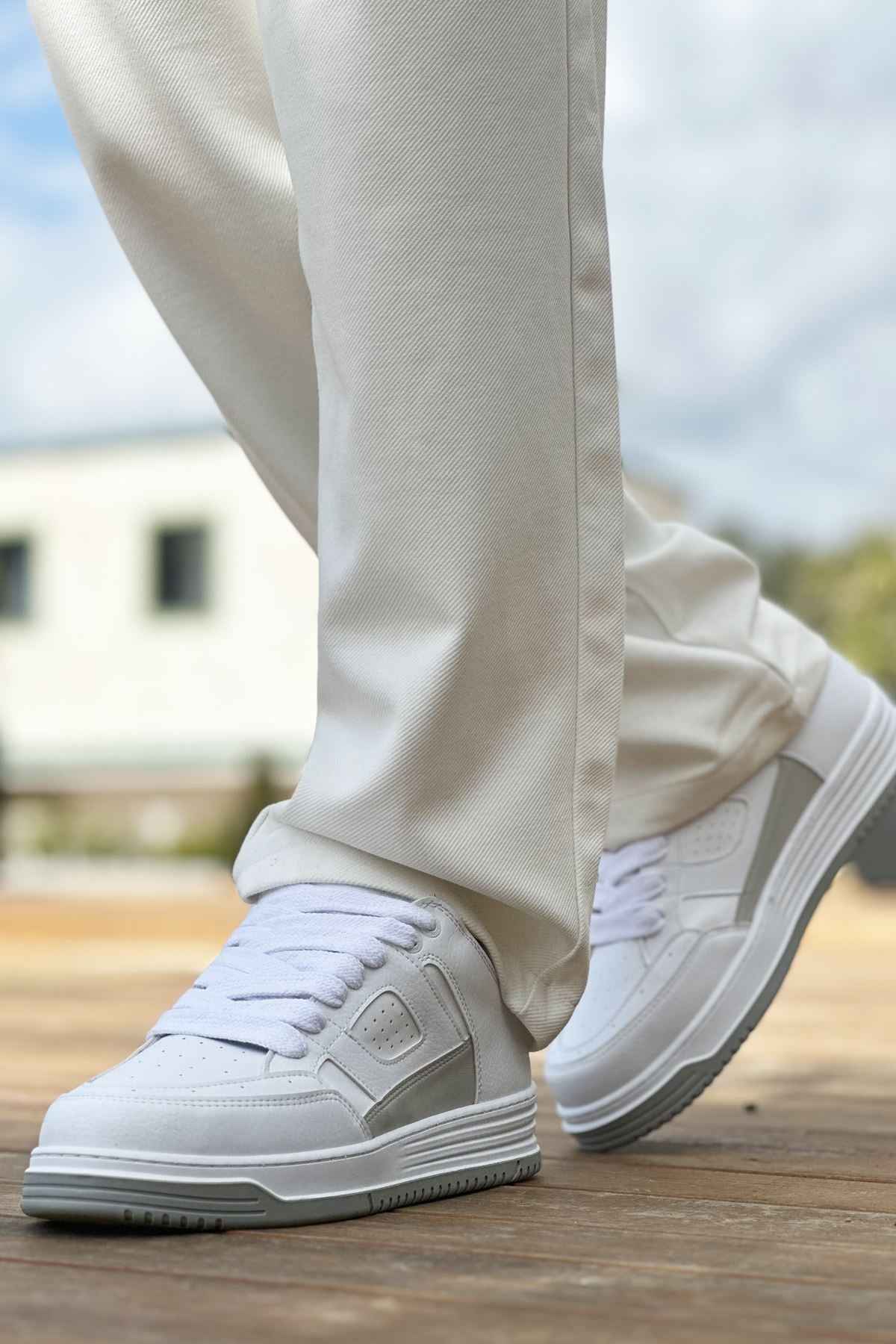Men's white low-top sneakers with lace-up front and textured rubber sole