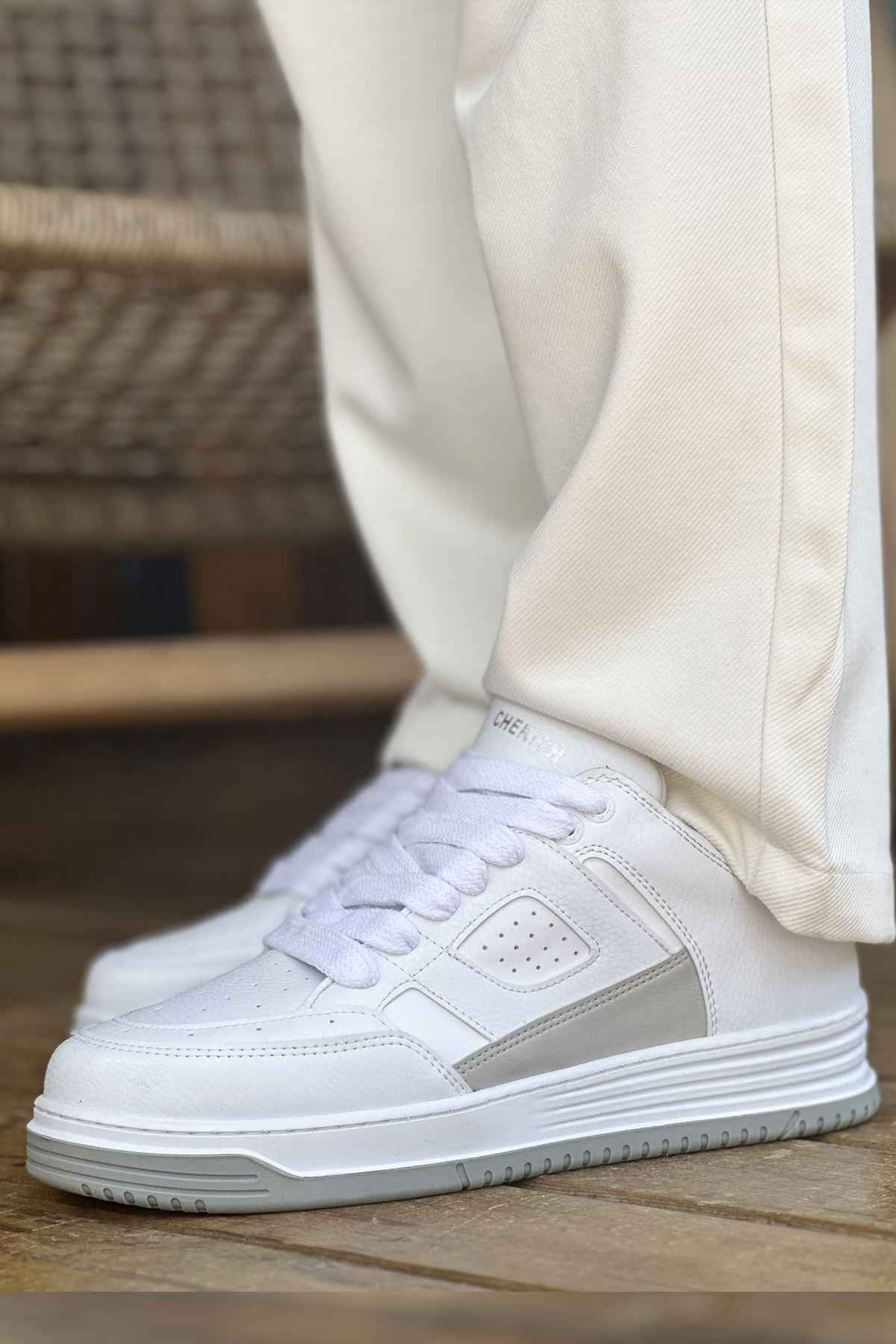 Men's white lace-up sneakers showing side panel and padded collar