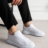 White lace-up low-top sneakers with textured upper and rubber sole
