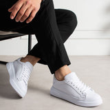 White lace-up low-top sneakers with cushioned collar and rubber sole