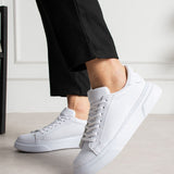 White lace-up sneakers with side stitch detail and rubber sole