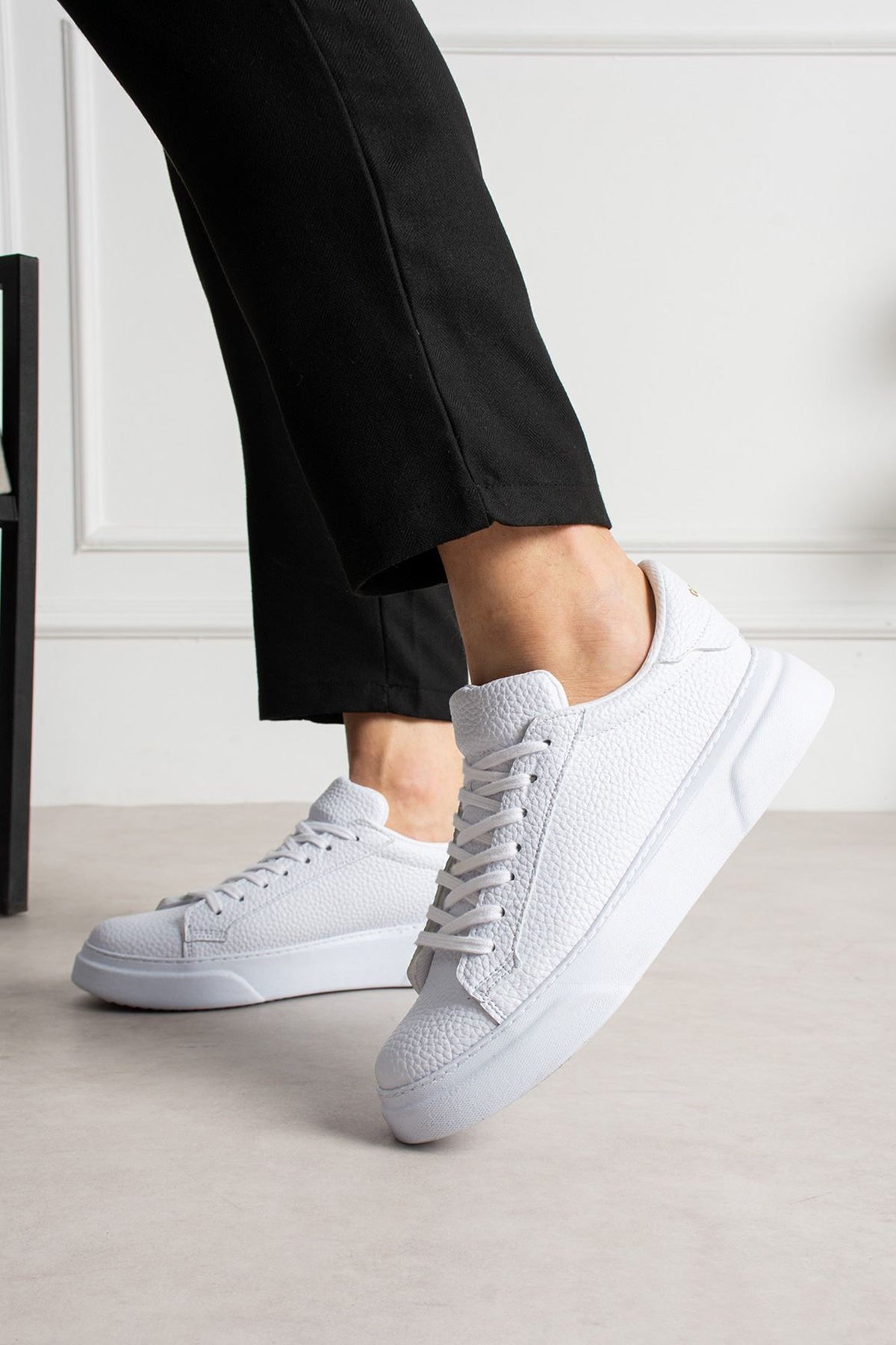 White lace-up sneakers with side stitch detail and rubber sole