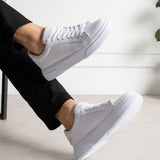 White lace-up low-top sneakers with stitched toe cap and rubber sole