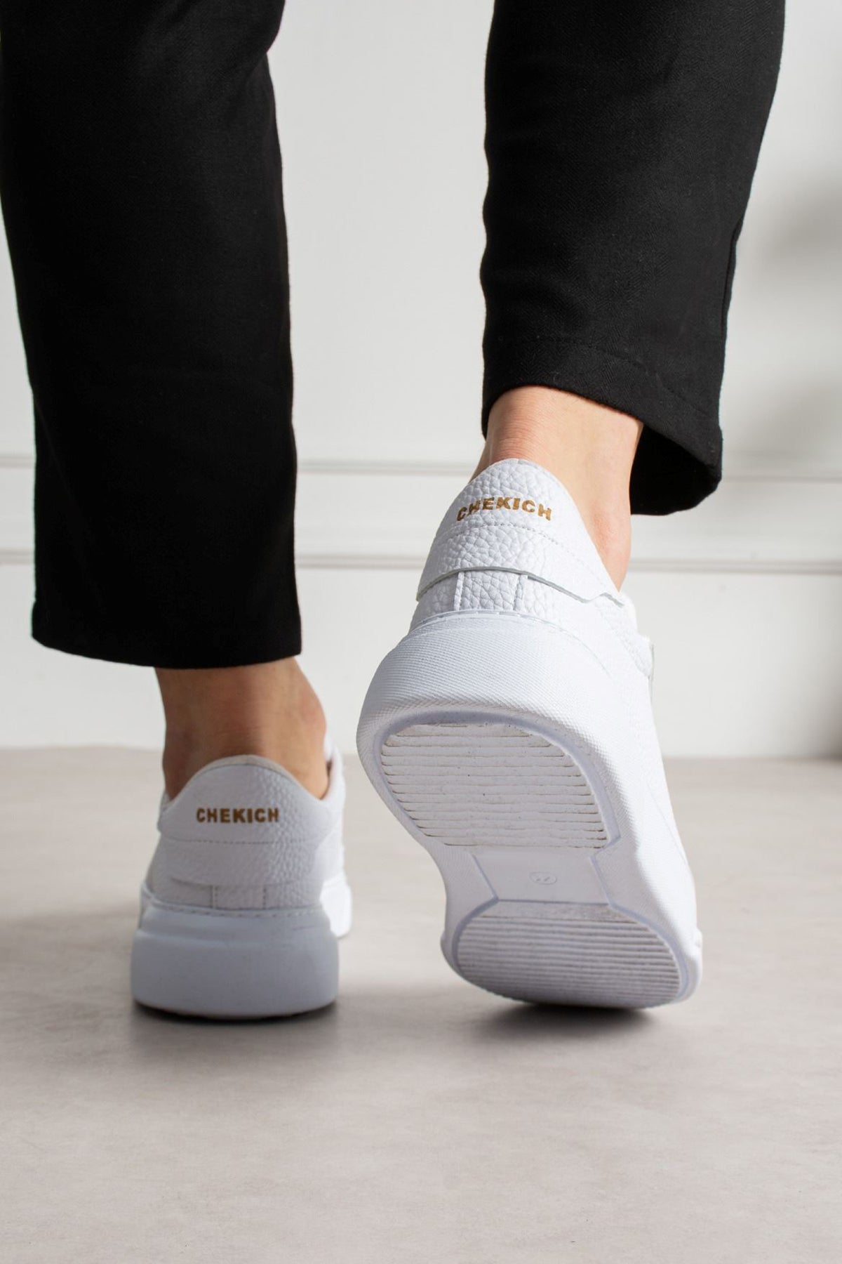 White lace-up sneakers with 'CHEKICH' heel logo and rubber outsole