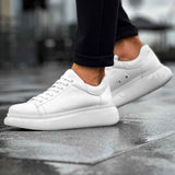 White low-top sneakers with lace-up front and smooth toe cap