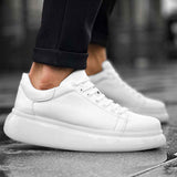 White low-top sneakers, side view with lace-up and eyelet detailing