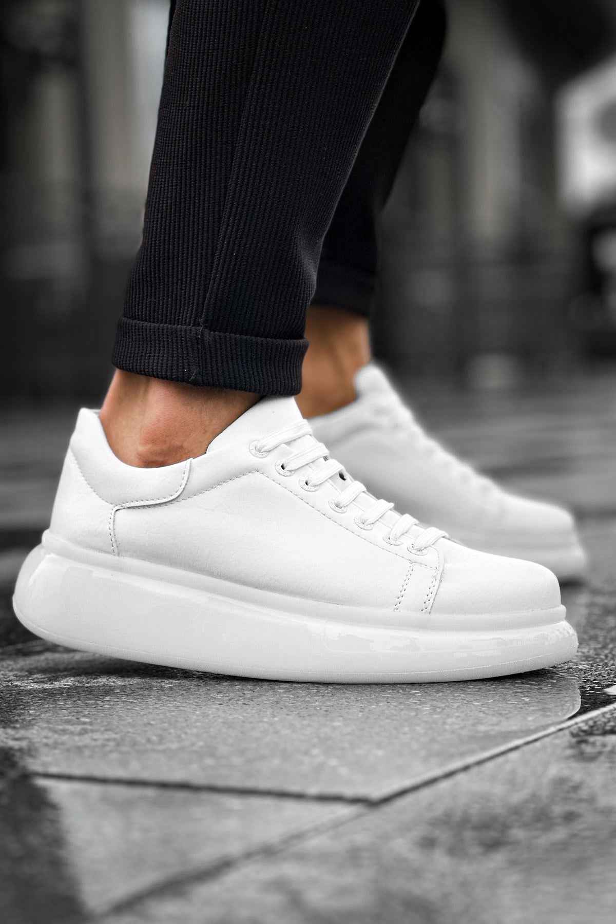 White low-top sneakers, side view with lace-up and eyelet detailing