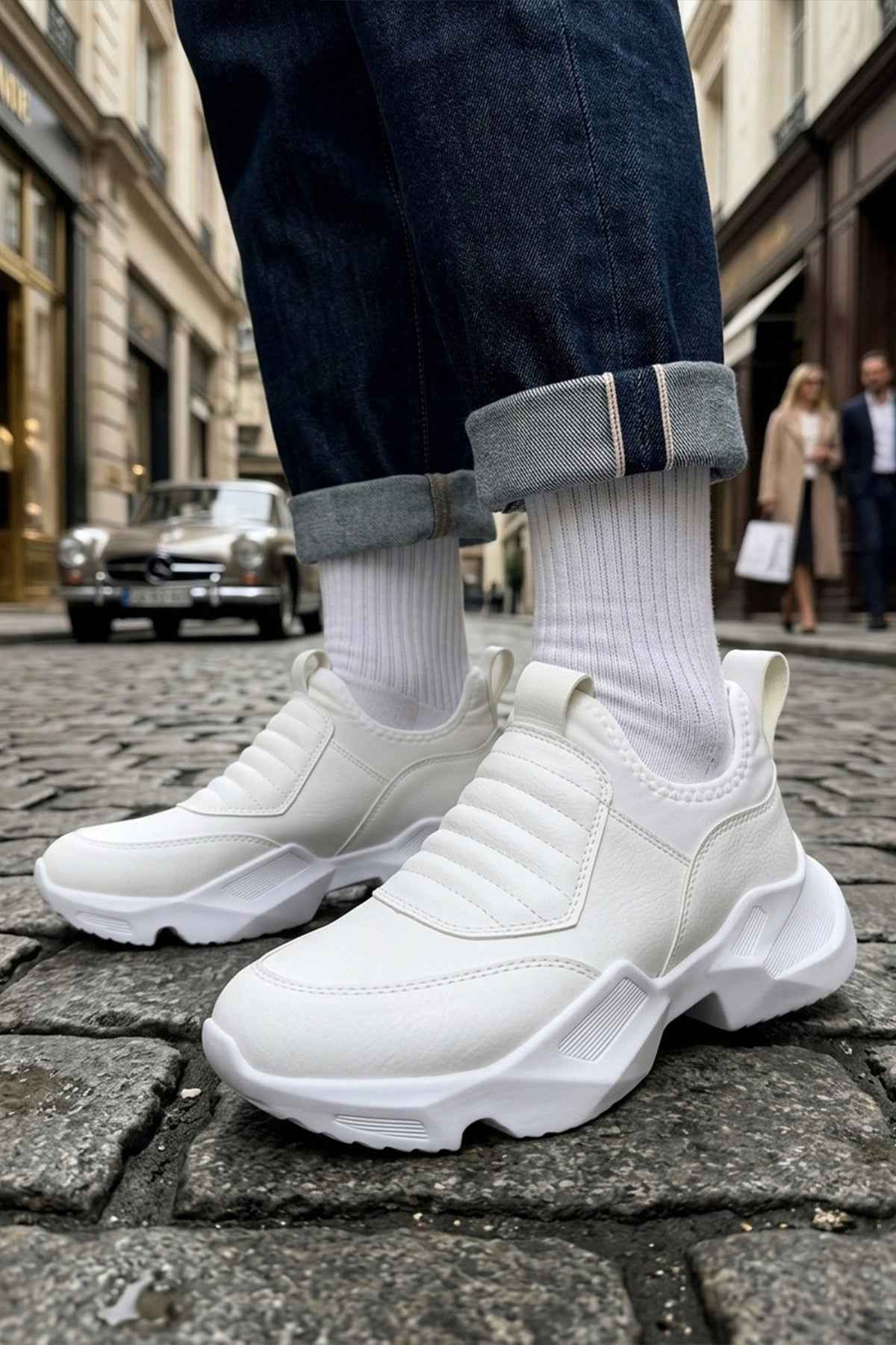 White sock-style sneakers with ribbed knit collar and thick white tread sole