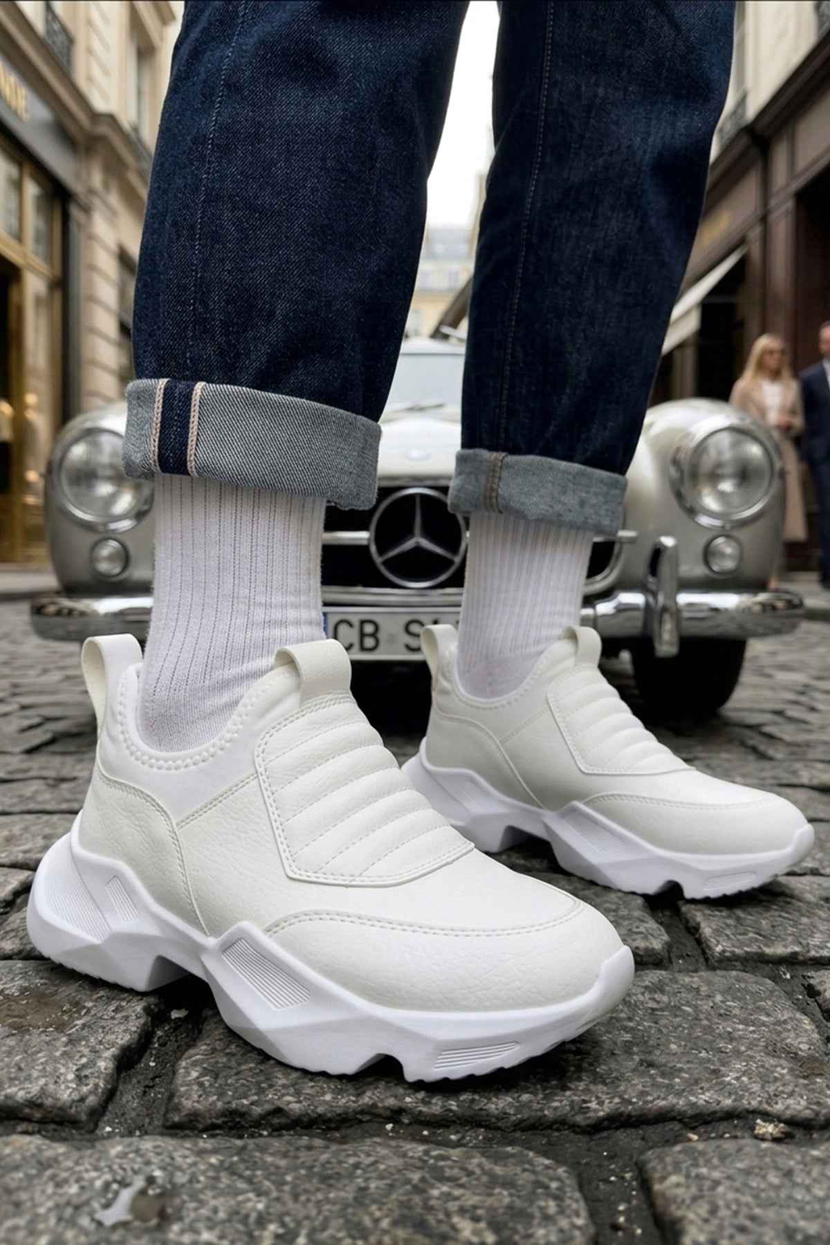 White sock sneakers with ribbed cuff and thick tread sole, side view