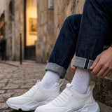 White sock sneakers with ribbed knit cuffs and chunky sole, street side view