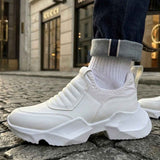 White sneakers with ribbed knit collar and thick tread sole, front 3/4 view