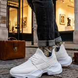 Men's white sneakers, side view with padded collar and chunky outsole tread