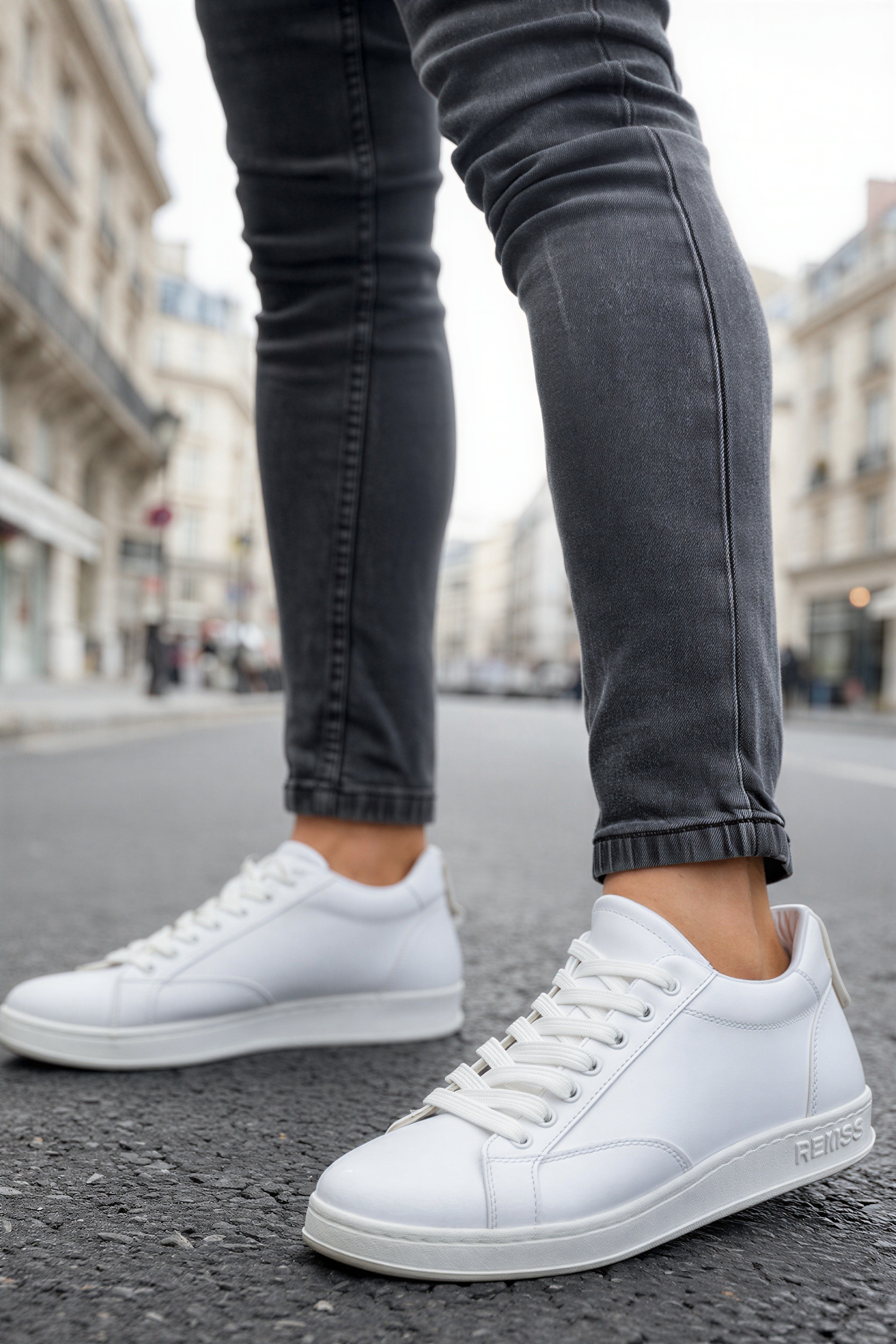 Men's white low-top sneakers with lace-up front, side view.