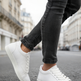 Men's white lace-up sneakers, quarter side view.