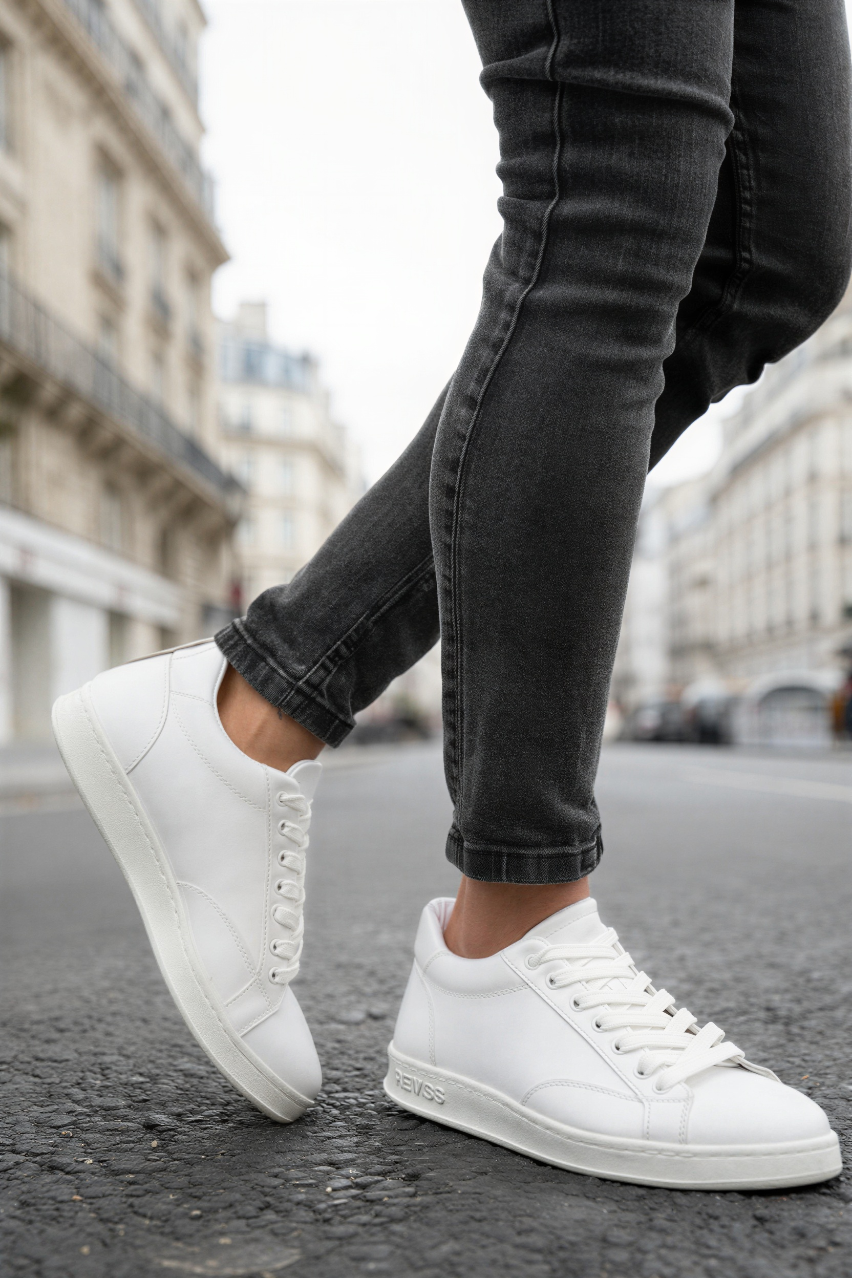 Men's white lace-up sneakers, quarter side view.