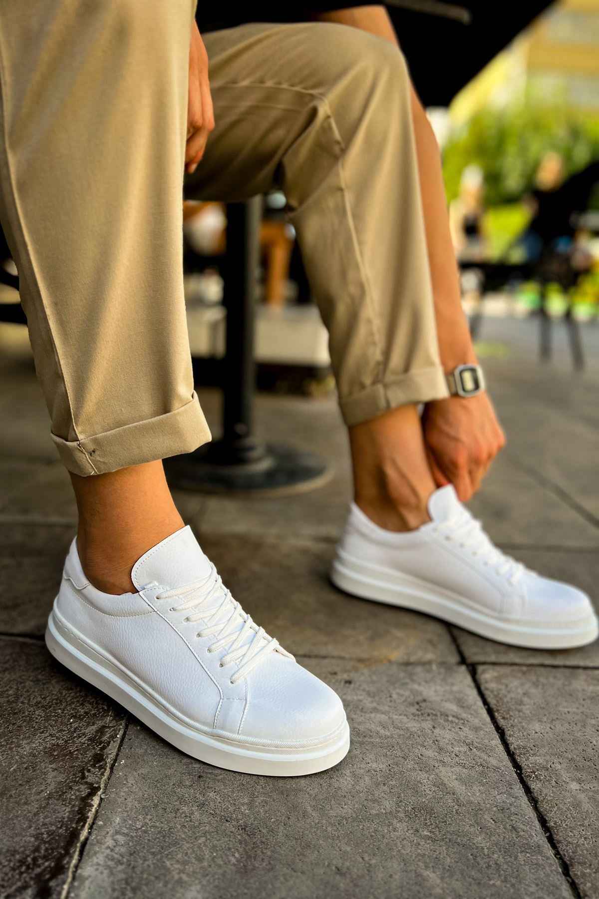 White low-top lace-up sneakers with smooth upper and white rubber sole