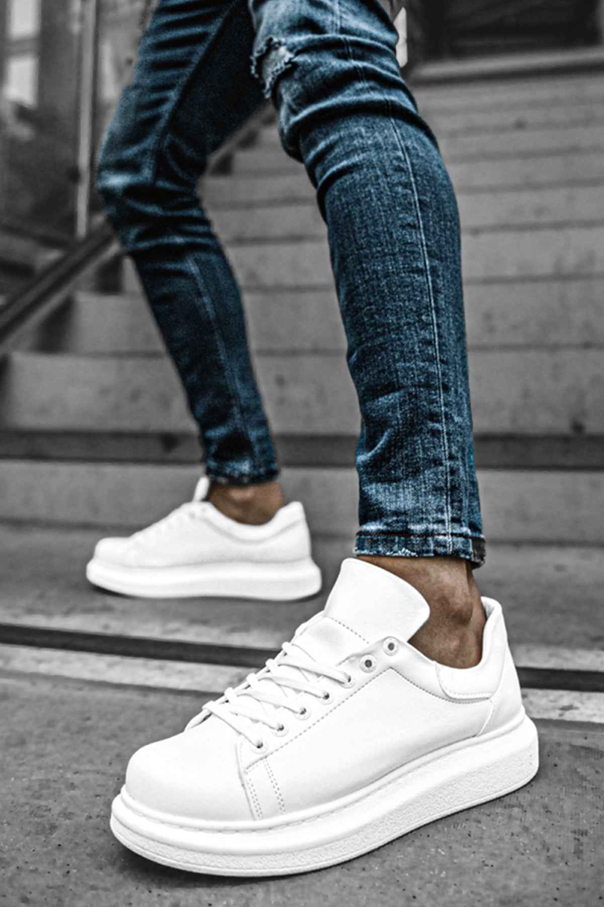 White low-top sneakers with lace-up front and stitched side panels