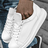 White low-top sneakers, close-up of lace-up front and padded tongue