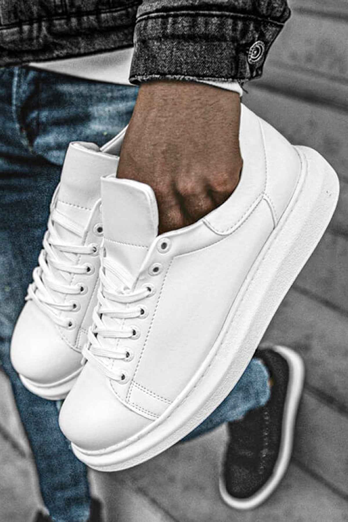 White low-top sneakers, close-up of lace-up front and padded tongue