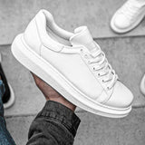 White low-top sneakers with rounded toe and low rubber sole