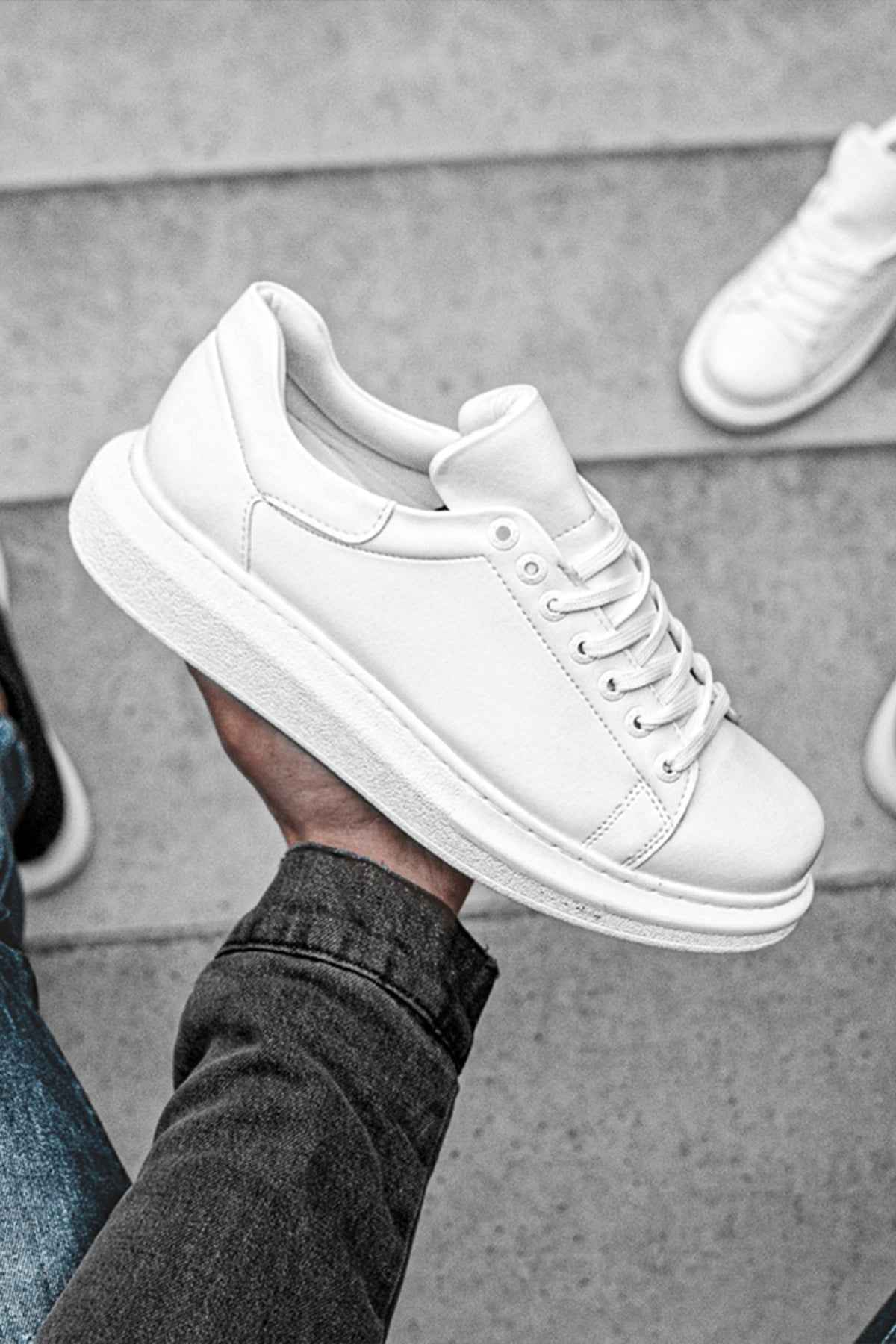 White low-top sneakers with rounded toe and low rubber sole