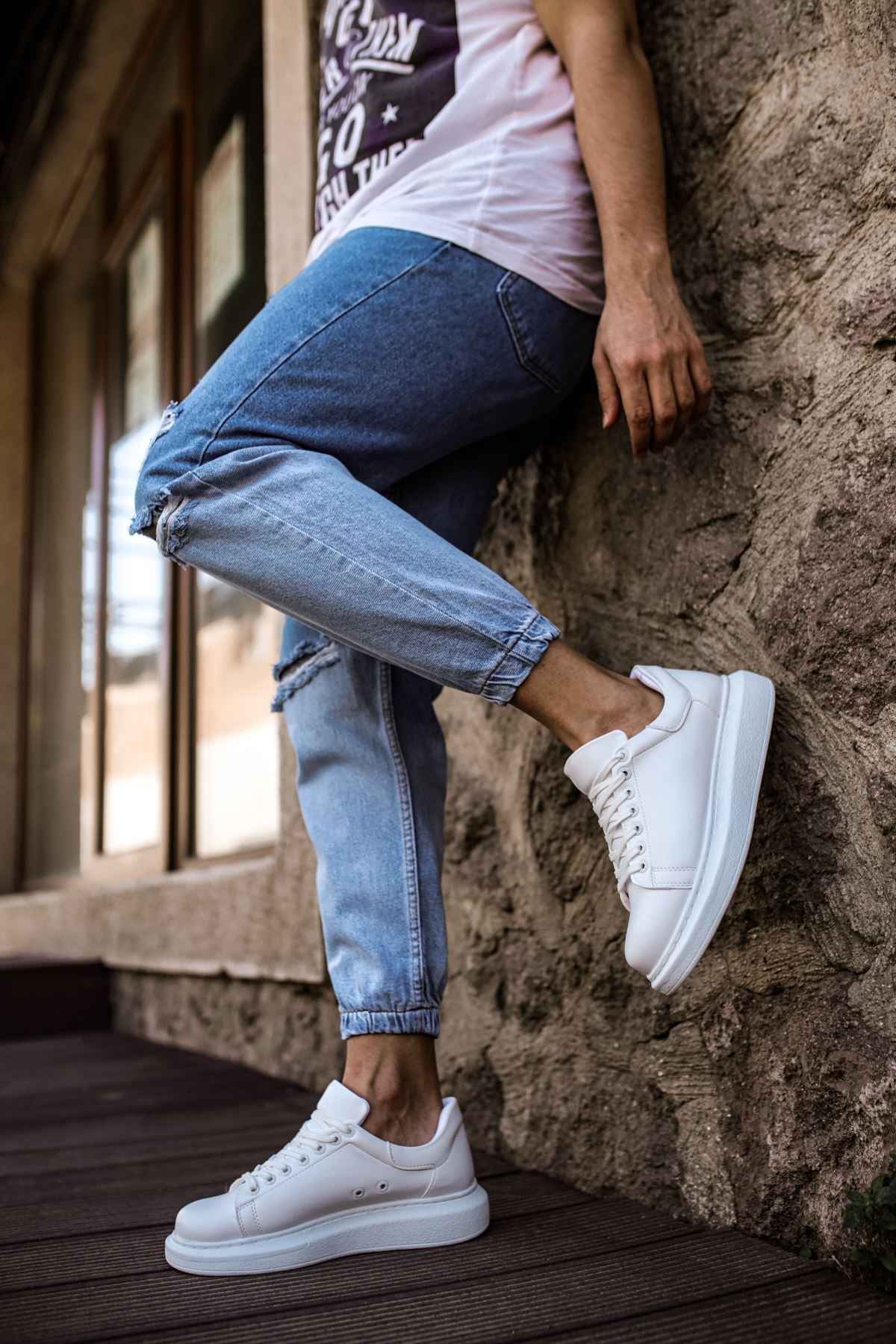 White low-top sneakers with white laces and thick rubber sole