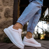 White low-top sneakers, side view with lace-up and cushioned collar