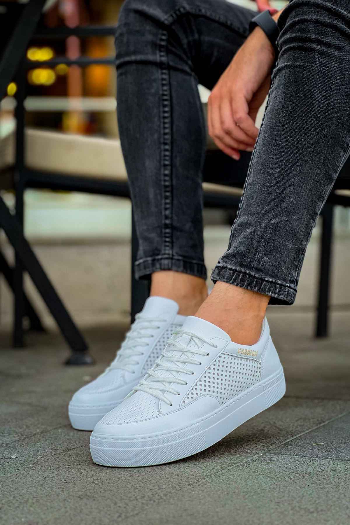 White lace-up sneakers, perforated uppers, and low-profile rubber sole