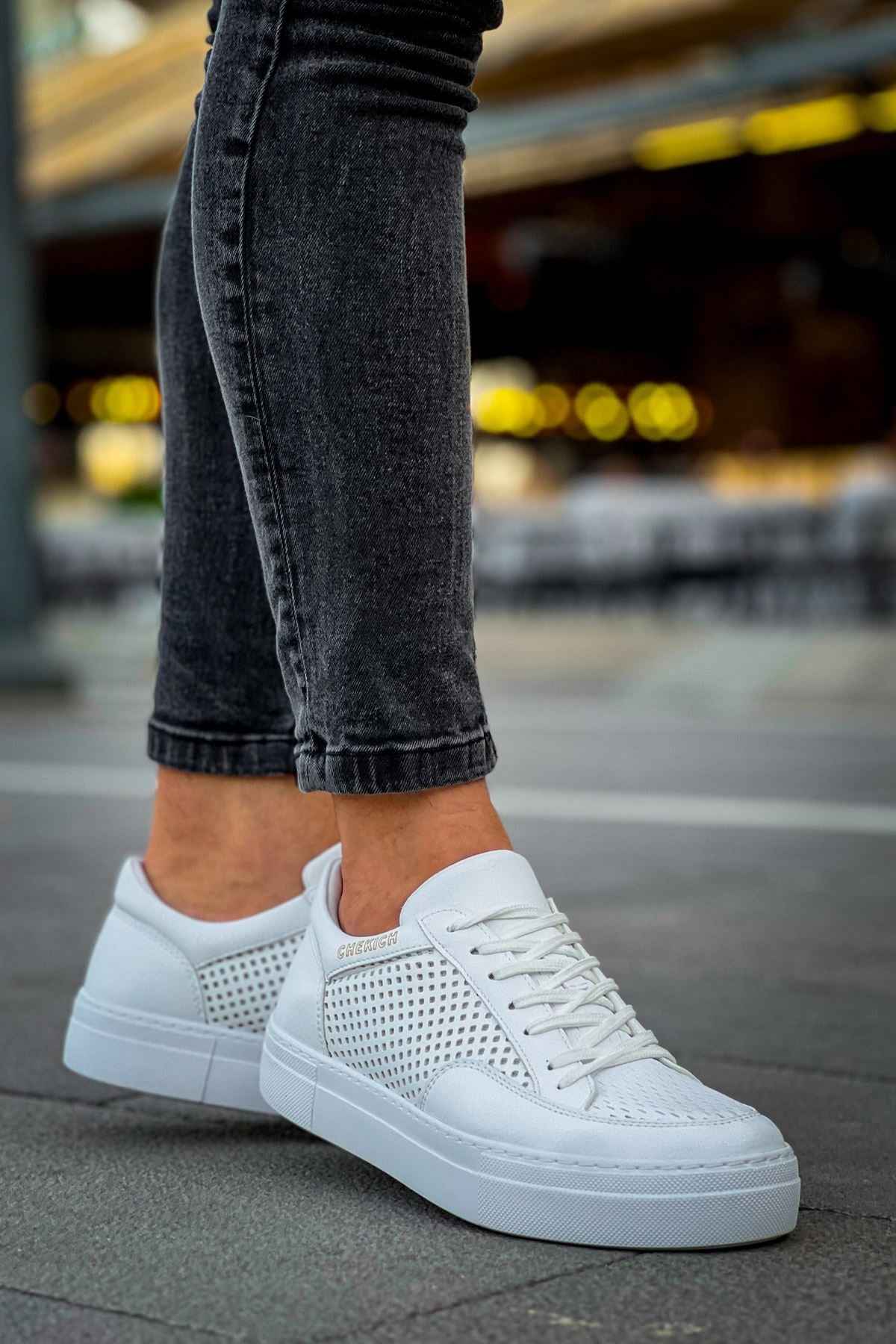 White sneakers with perforated sides and lace-up front