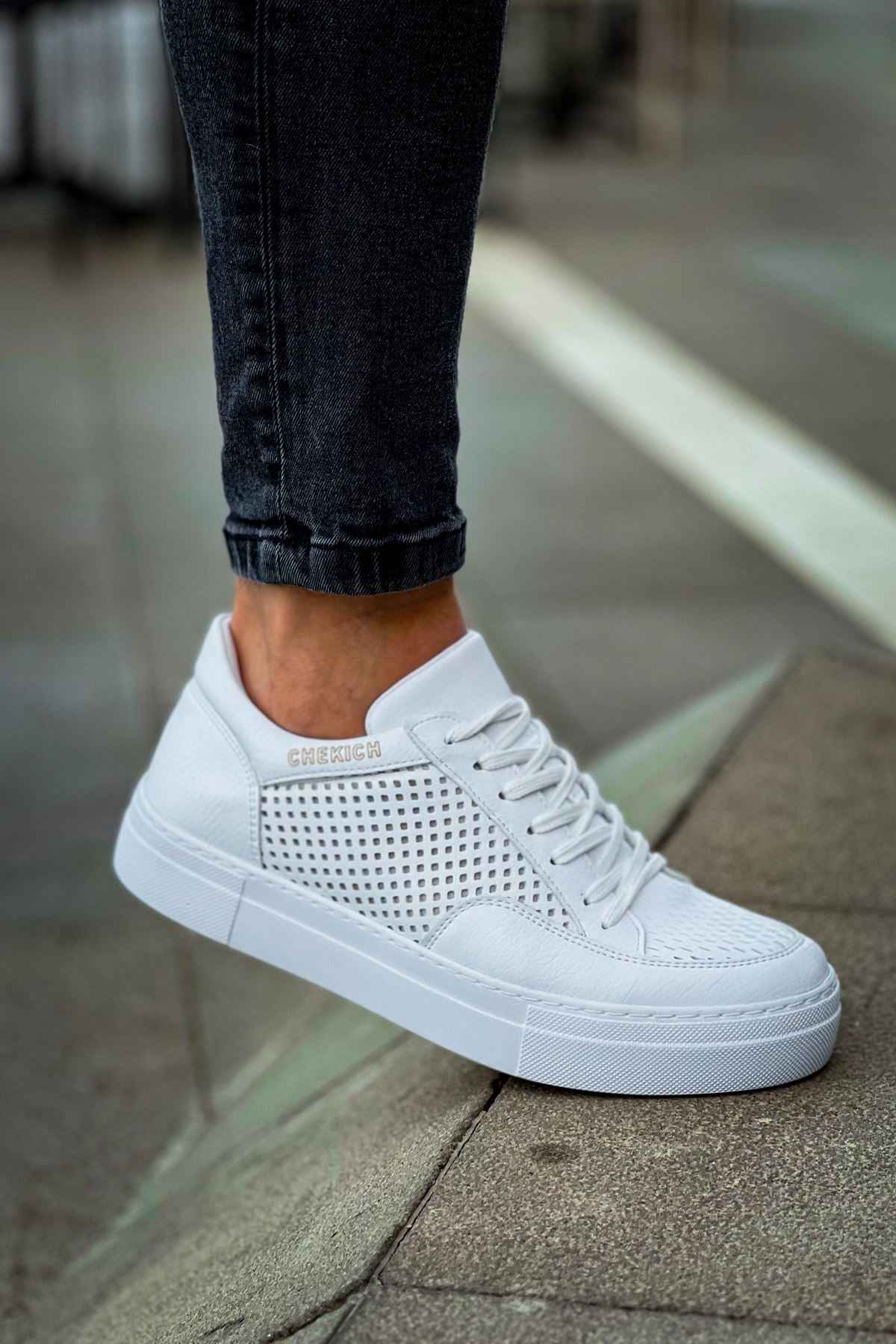 White lace-up sneaker with perforated toe and side panels