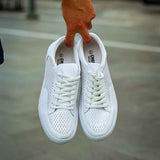White sneakers shown from back, lace-up with perforated panels