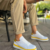 Men's white low-top sneakers with yellow side stripe and lace-up front