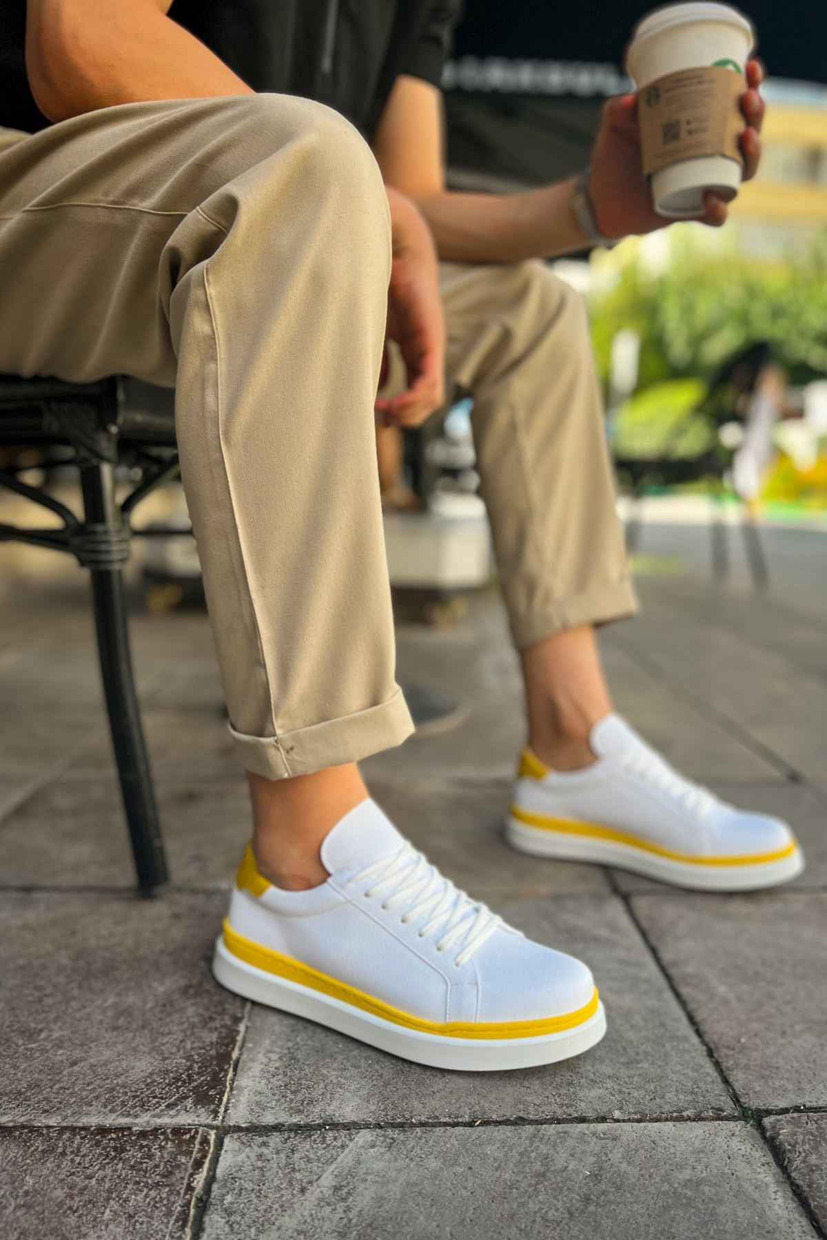 Men's white low-top sneakers with yellow side stripe and lace-up front