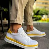 Men's white low-top sneakers with yellow trim and lace-up design