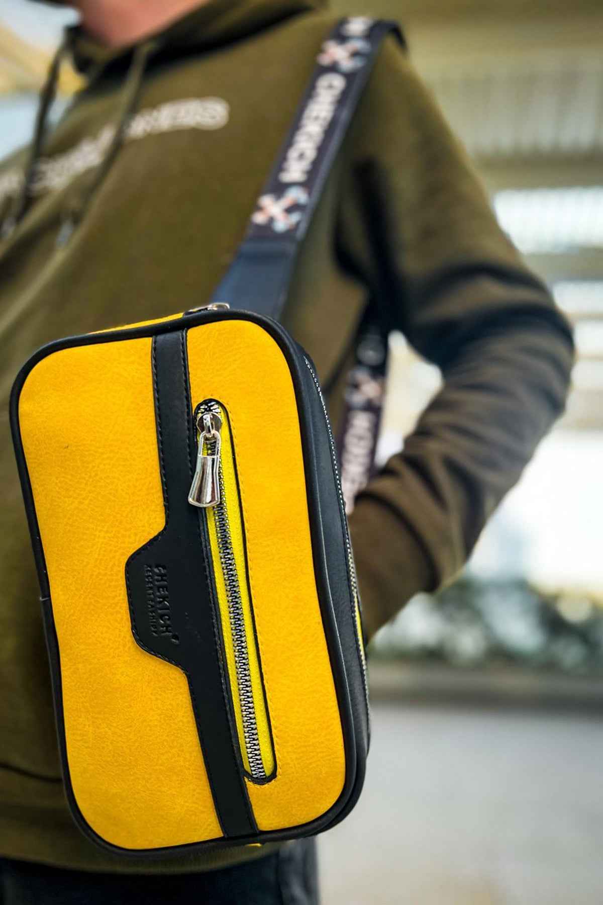 Men's yellow CH101 tablet bag with black trim and front zip pull