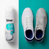 White shoe whitener bottle and two lace-up sneakers, one white one gray