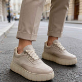 Beige suede lace-up sneakers with textured panels and chunky rubber sole