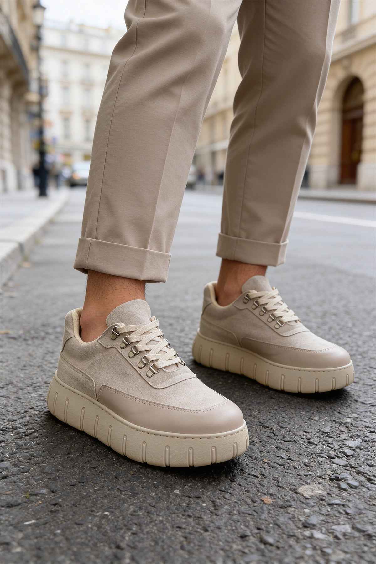 Beige suede lace-up sneakers with textured panels and chunky rubber sole