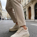 Beige suede sneakers with lace-up closure and thick rubber outsole