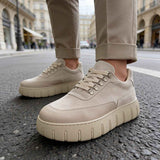 Beige suede sneakers with lace-up front and cushioned rubber sole
