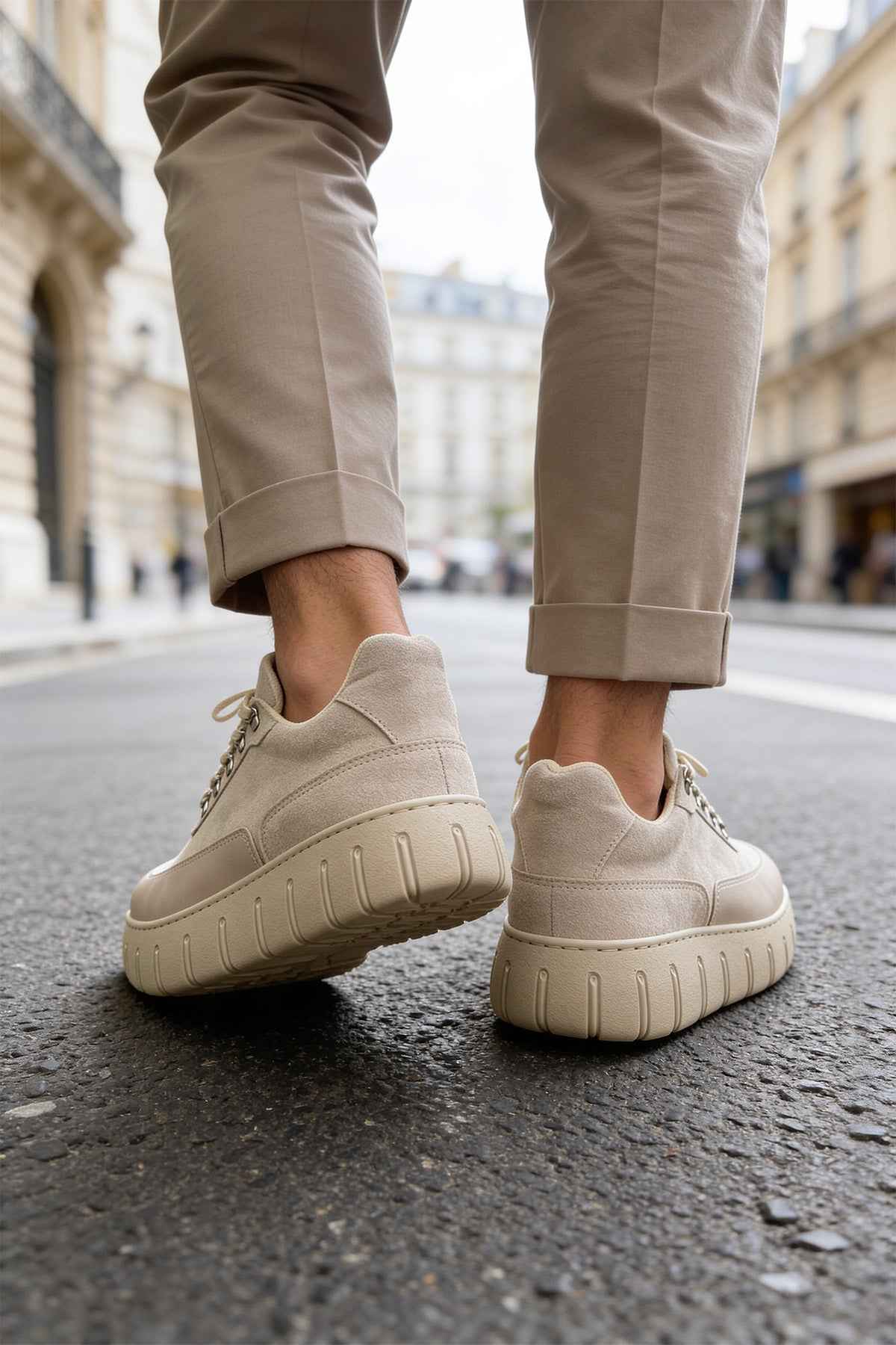 Beige suede sneakers, rear view with treaded rubber sole and lace-up detail