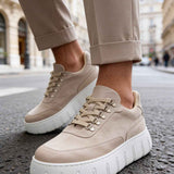 Men's beige suede lace-up sneakers with white cushioned soles and eyelets