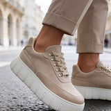 Men's beige suede lace-up sneakers, front angled view, white platform sole