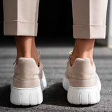 Men's beige suede sneakers, rear view, white sole and heel with pull tab