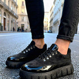Men's black suede lace-up sneakers with chunky rubber sole, glossy side panel