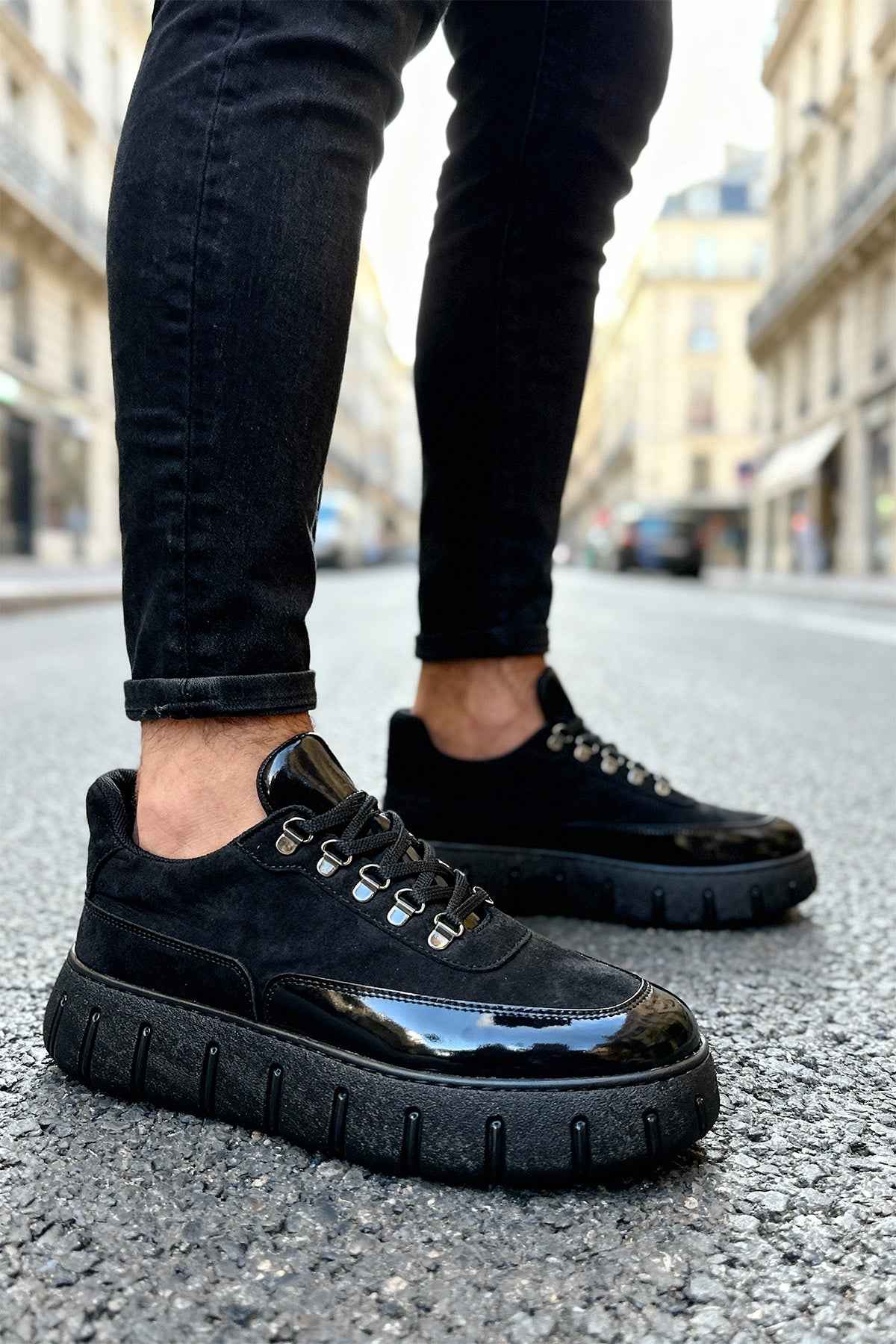 Men's black lace-up sneakers with chunky sole and metal eyelets, side view