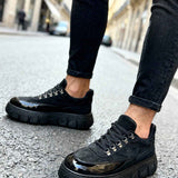 Men's black suede lace-up sneakers with thick tread sole and shiny toe cap