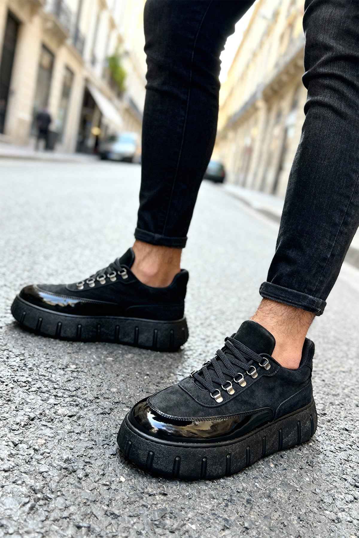 Men's black suede lace-up sneakers with thick tread sole and shiny toe cap
