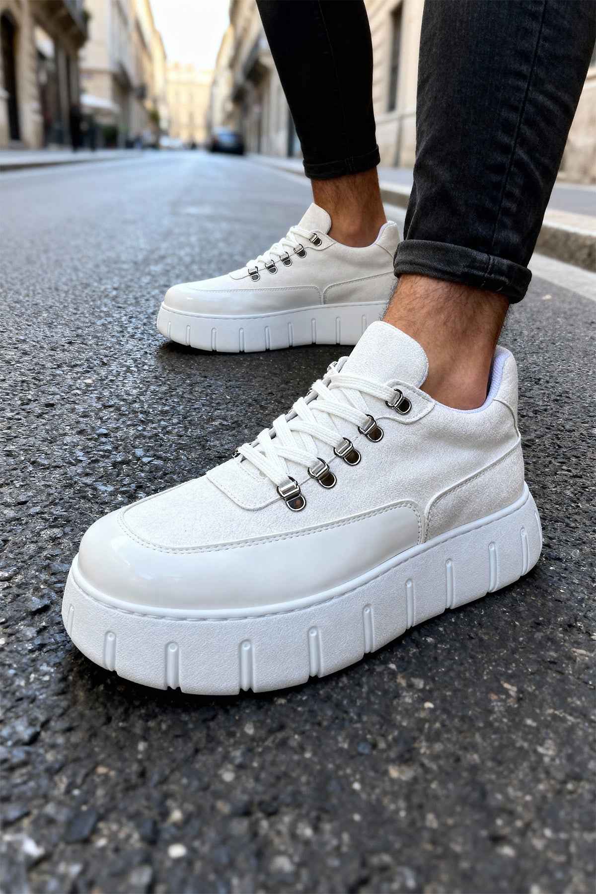 White suede lace-up sneakers with thick sole, angled side view.